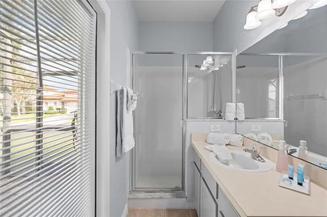 a bathroom with a tub sink and mirror