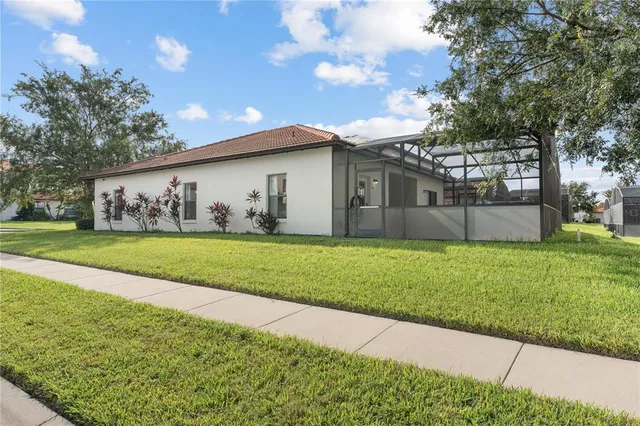 a view of house with backyard and garden