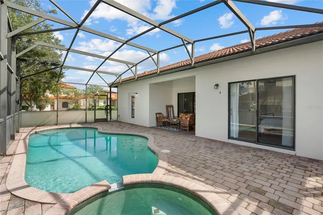 a view of a backyard with a patio and a yard