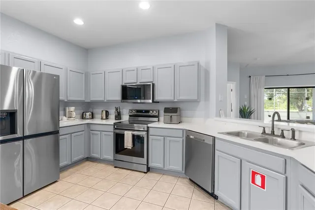 a kitchen with a sink cabinets and stainless steel appliances