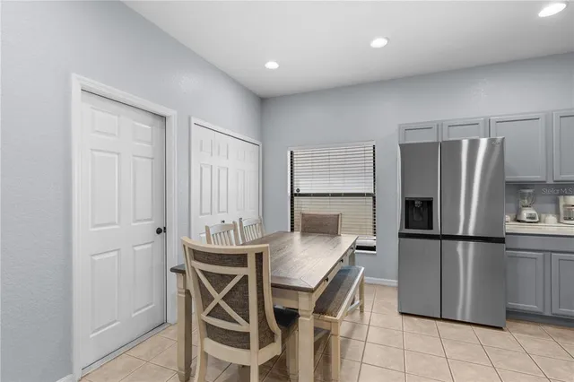 a kitchen with stainless steel appliances granite countertop a refrigerator and a stove top oven