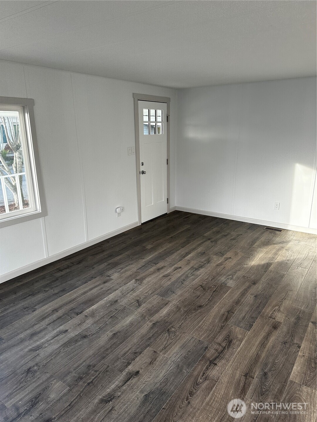 201 Union Avenue Southeast, Unit 249 Renton, WA 98059 - Photo 3 of 15 a view of an empty room with wooden floor and a window