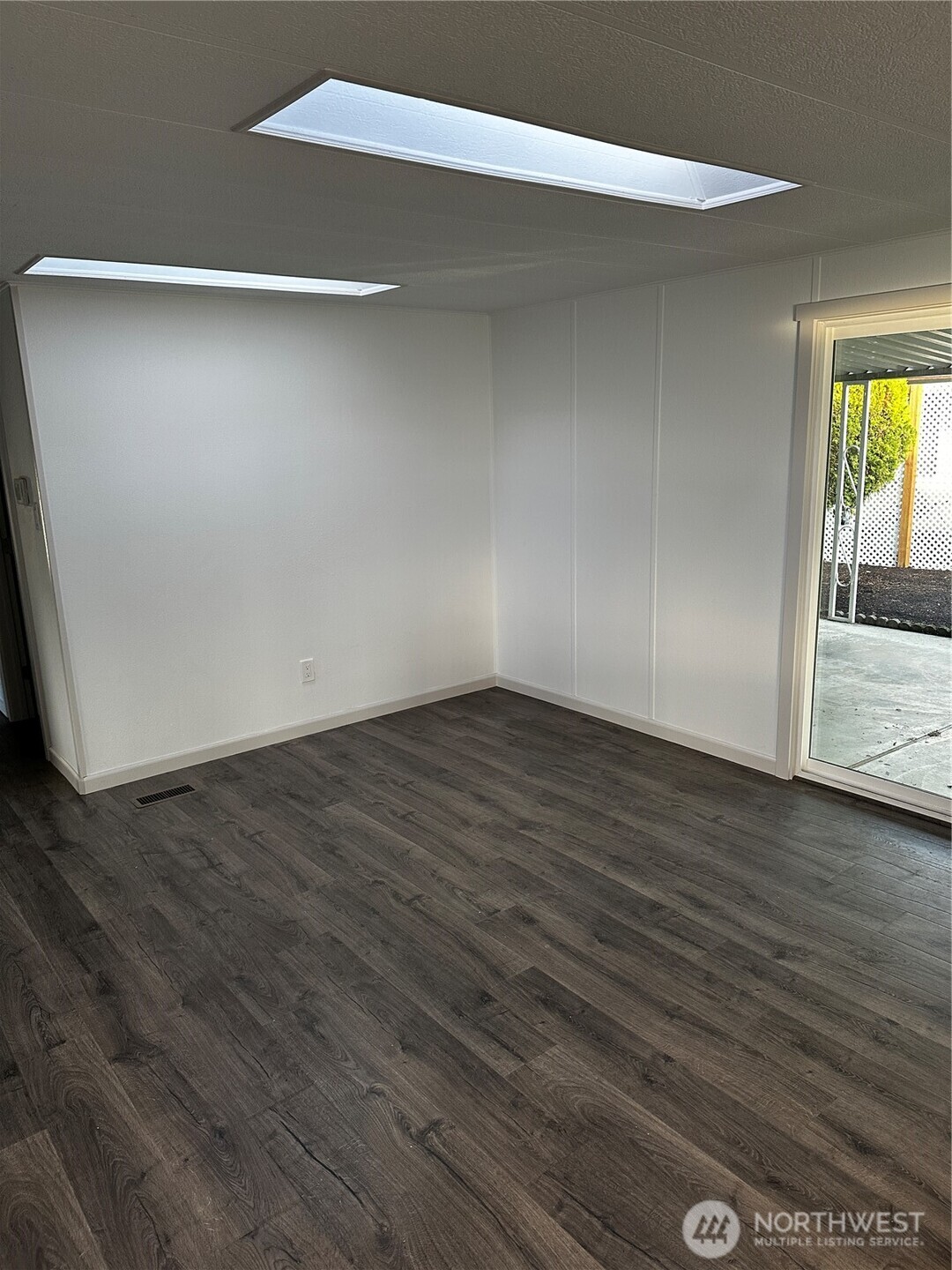 201 Union Avenue Southeast, Unit 249 Renton, WA 98059 - Photo 5 of 15 a view of an empty room with wooden floor and a window