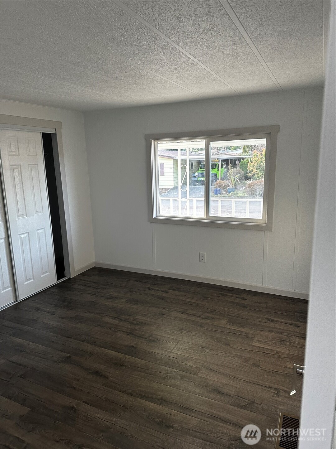 201 Union Avenue Southeast, Unit 249 Renton, WA 98059 - Photo 7 of 15 an empty room with wooden floor and windows