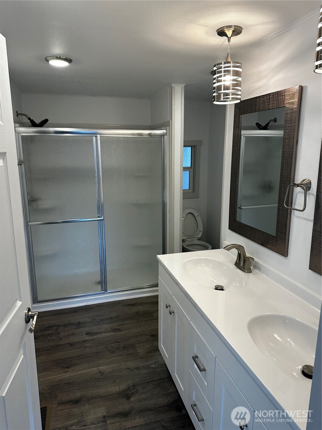 201 Union Avenue Southeast, Unit 249 Renton, WA 98059 - Photo 10 of 15 a bathroom with a sink a large mirror and a shower
