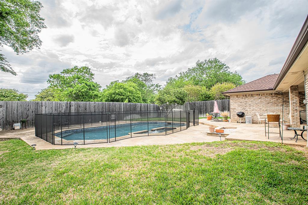 3309 Timber View Circle Bedford, TX 76021 - Photo 33 of 38 a view of a backyard with a slide and a slide