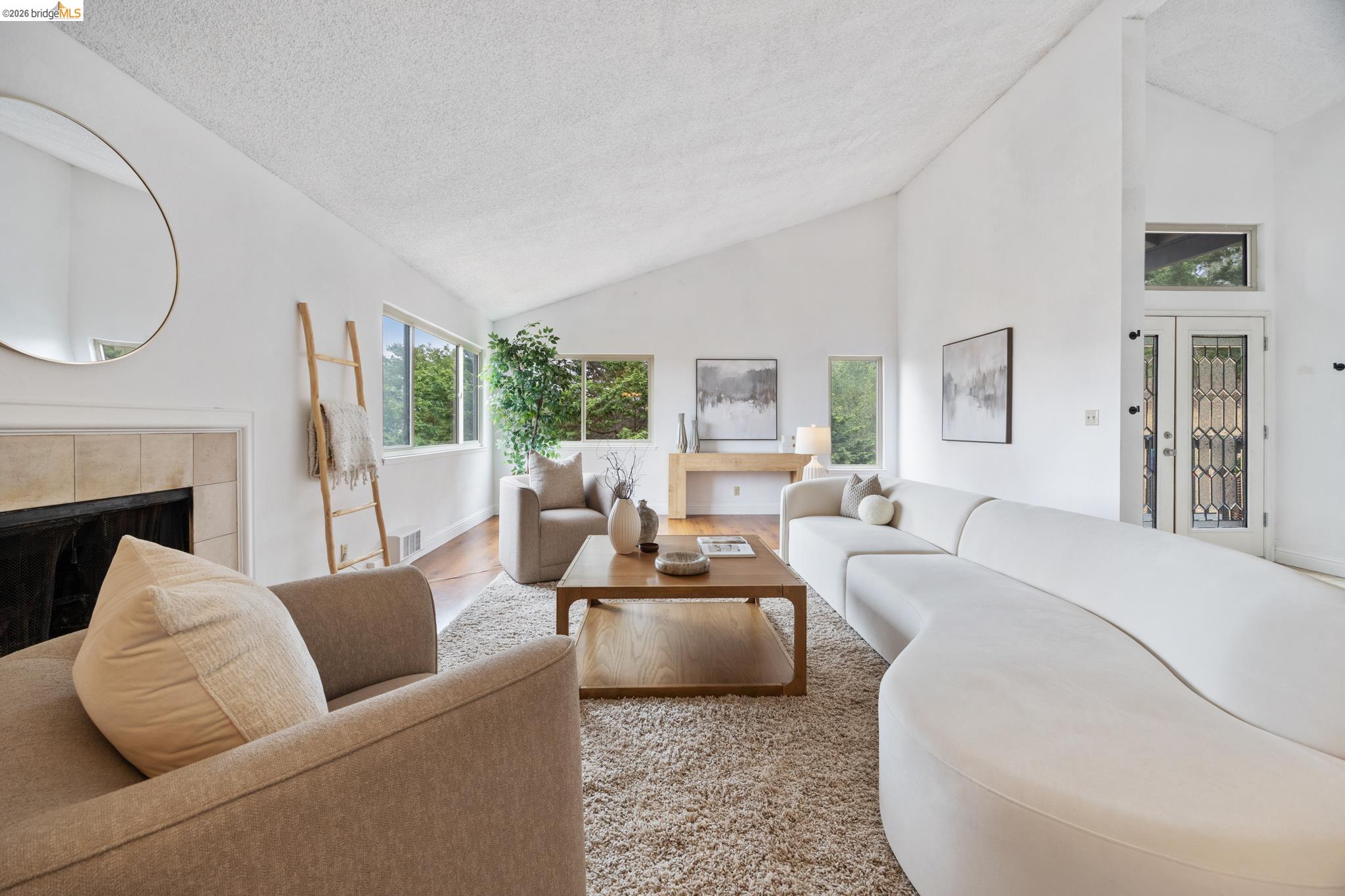 201 Vista Heights Road El Cerrito, CA 94530 - Photo 4 of 32 Vaulted ceilings featuring white walls and a fireplace with a tile surround