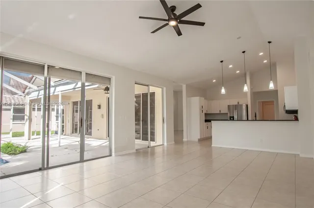 a view of a living room a refrigerator and windows