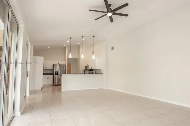 a view of a living room a window and a kitchen