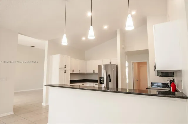 a kitchen with stainless steel appliances a refrigerator and a sink