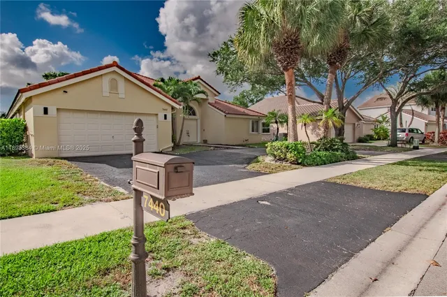 a front view of a house with garden