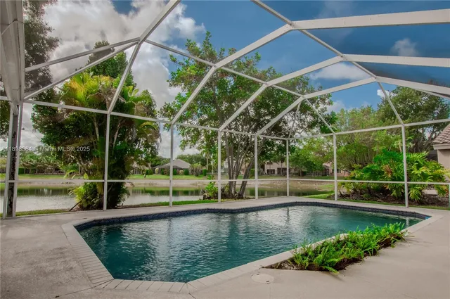 a view of a backyard with swimming pool
