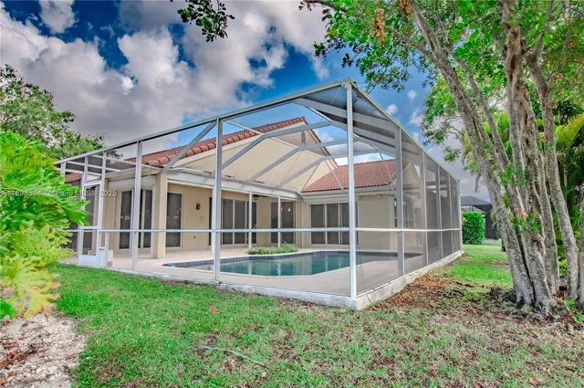 a view of a house with backyard and sitting area