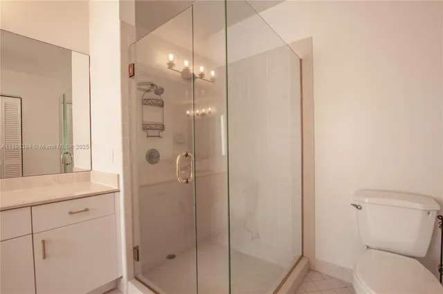 a bathroom with a shower a sink and mirror