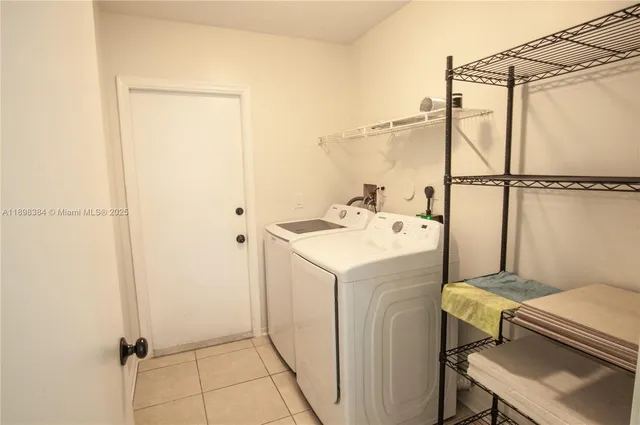 a view of a hallway with a livingroom and a bathroom