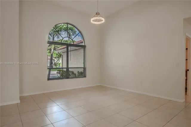 an empty room with a window and doors