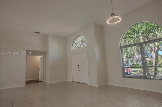 a view of an empty room with glass door