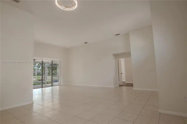 a kitchen with stainless steel appliances granite countertop a refrigerator a sink a stove a microwave and a refrigerator