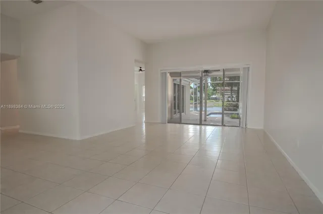a view of a dining room with furniture and a potted plant