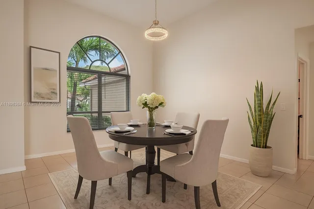 a living room with furniture and a wall painting