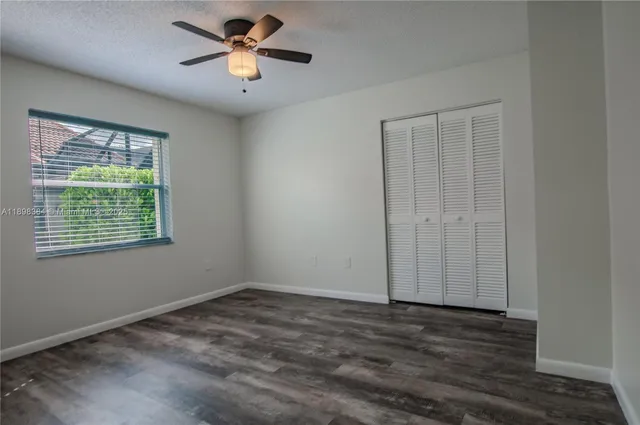 a view of a room with a ceiling fan and a window