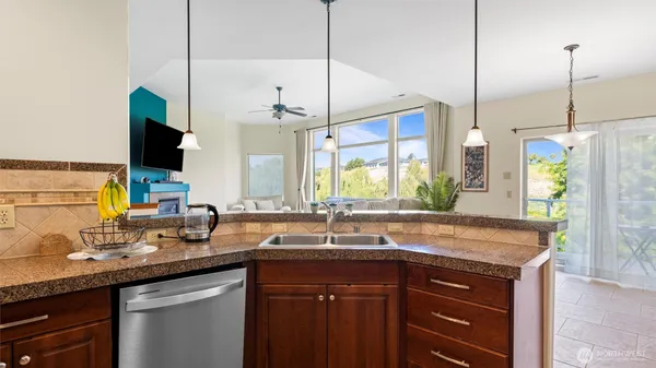 a kitchen with a sink and a wooden floor
