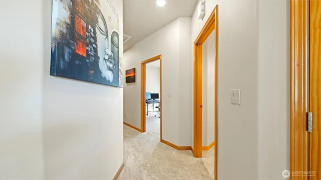 a view of a hallway with paintings on the wall