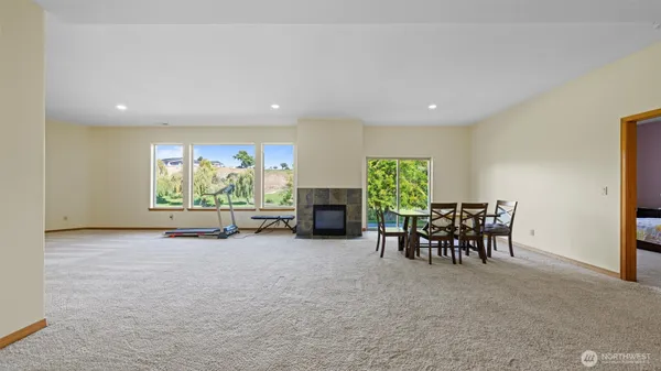a view of a room with gym equipment and floor to ceiling window