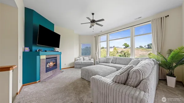 a living room with furniture a flat screen tv and a fireplace