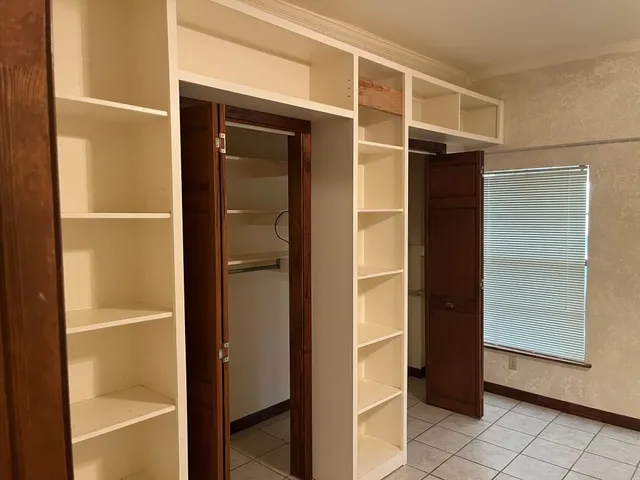 a view of a room with a door and a window