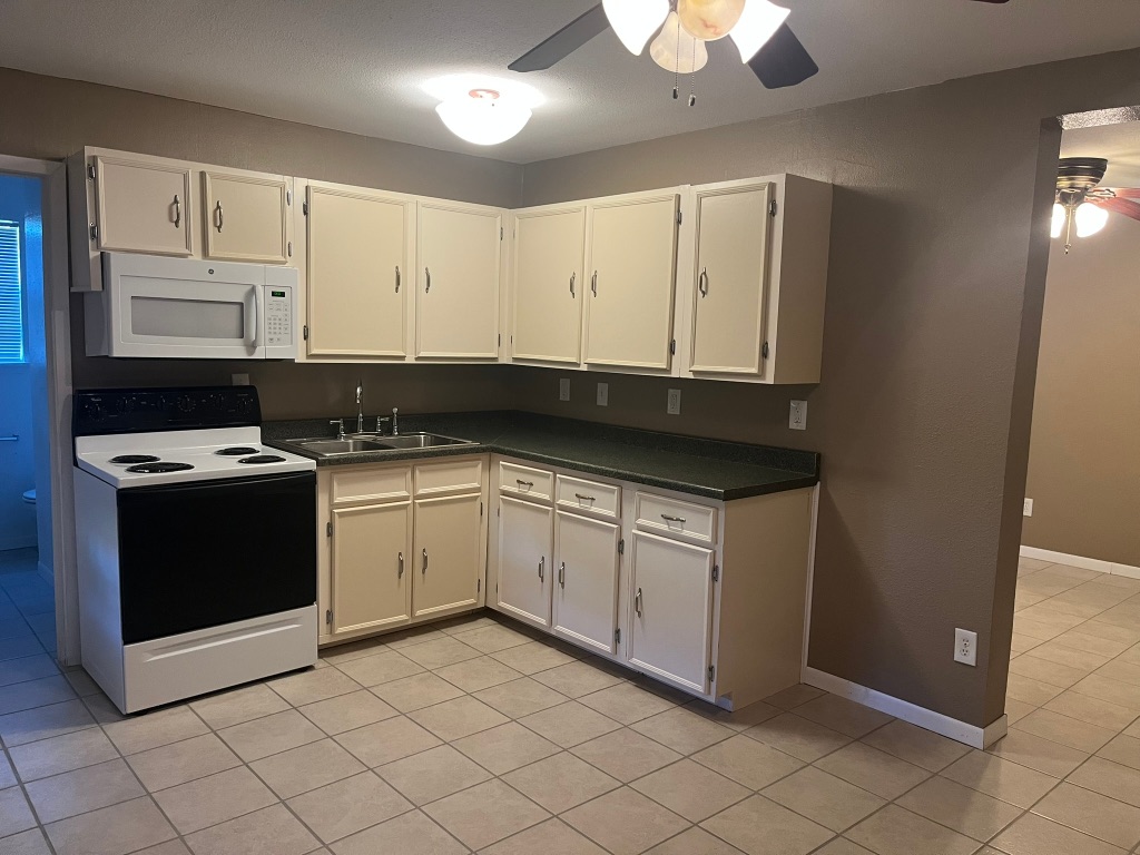 670 Farm To Market 1626 Buda, TX 78610 - Photo 3 of 15 a kitchen with stainless steel appliances granite countertop a stove a sink and a microwave