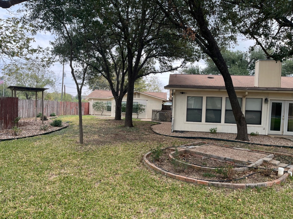 670 Farm To Market 1626 Buda, TX 78610 - Photo 7 of 15 a view of a house with backyard