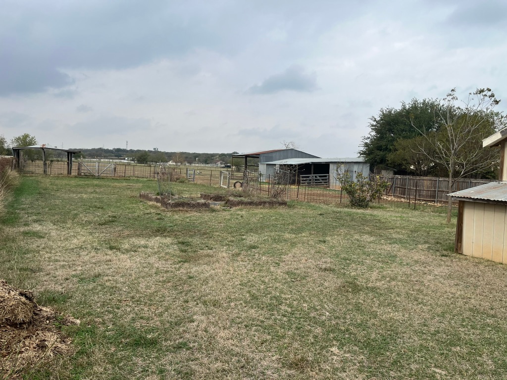 670 Farm To Market 1626 Buda, TX 78610 - Photo 8 of 15 a view of a house with a yard