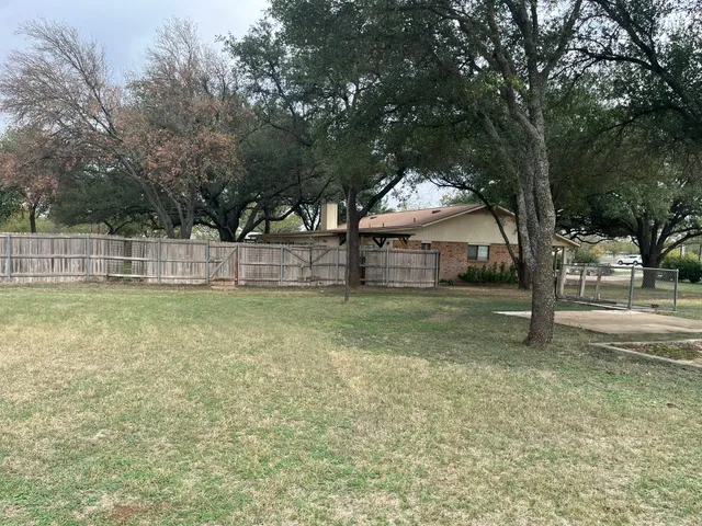 a view of a yard with a tree