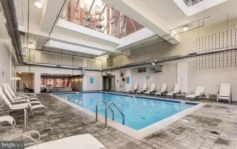 a kitchen with stainless steel appliances kitchen island granite countertop a sink and cabinets