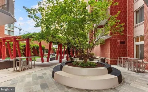 a view of a house with swimming pool and sitting area