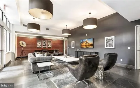 a living room with furniture and a chandelier