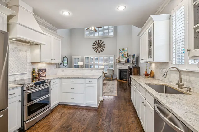 a kitchen with granite countertop cabinets sink and window