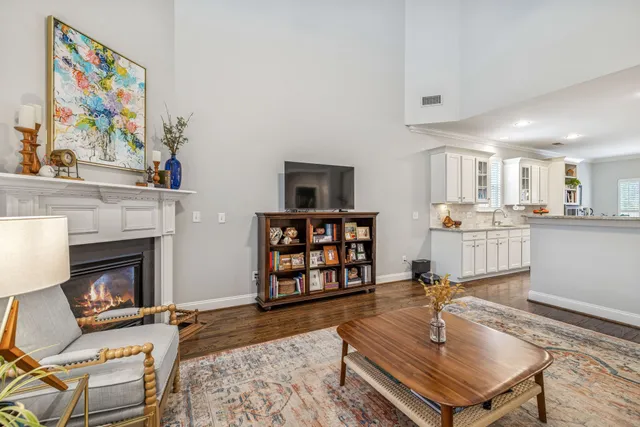 a living room with furniture a chandelier and a dining table