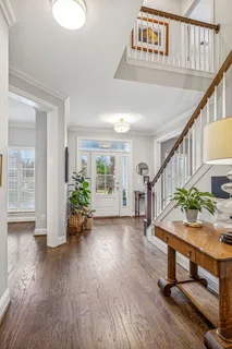 a view of an entryway with wooden floor and door