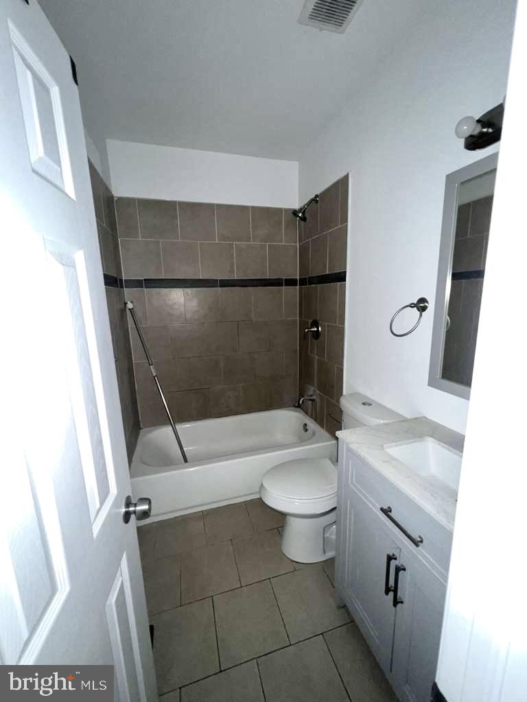 7034 North Broad Street Philadelphia, PA 19126 - Photo 4 of 13 a bathroom with a granite countertop sink toilet and shower