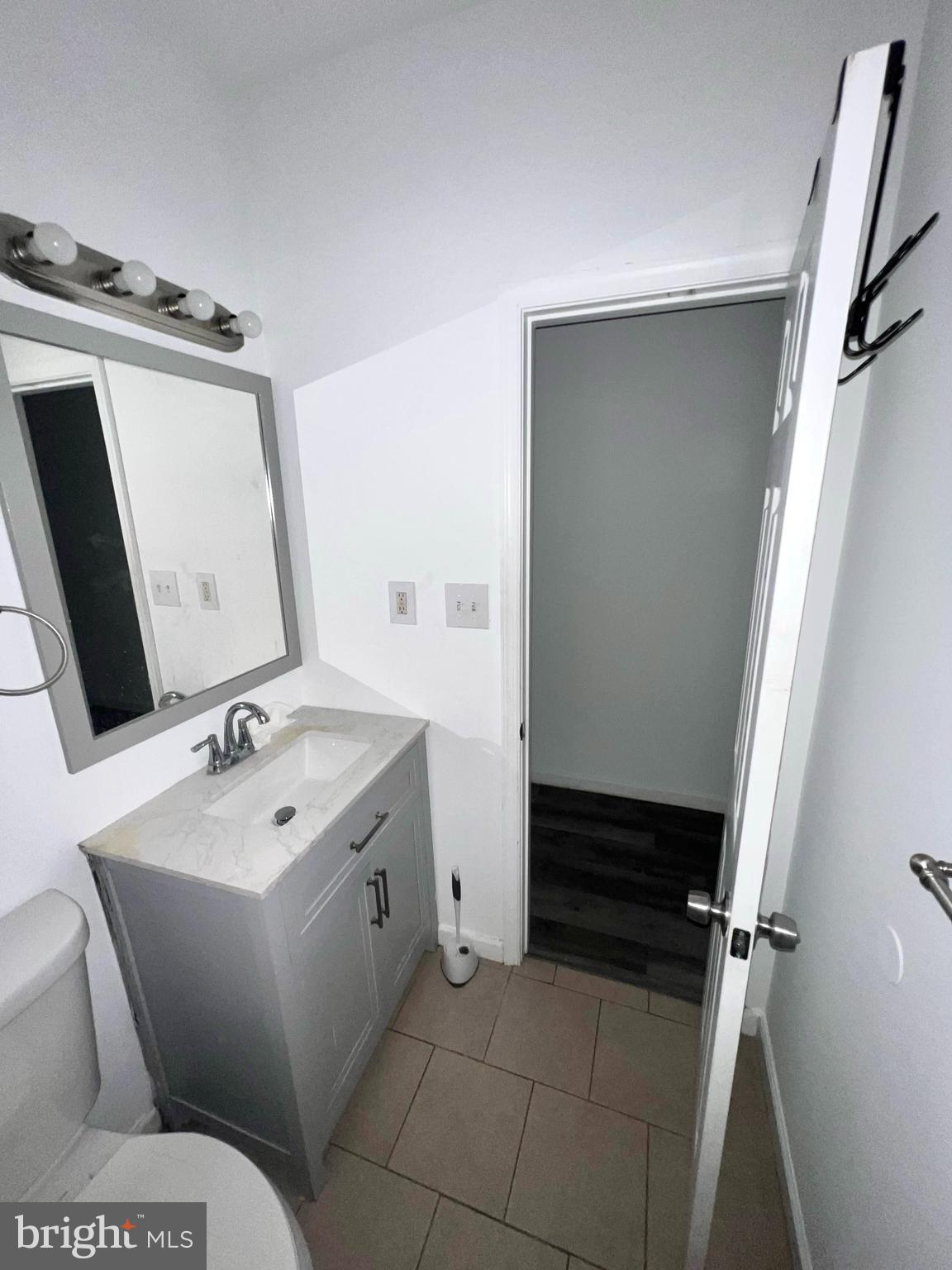 7034 North Broad Street Philadelphia, PA 19126 - Photo 5 of 13 a bathroom with a toilet sink and mirror