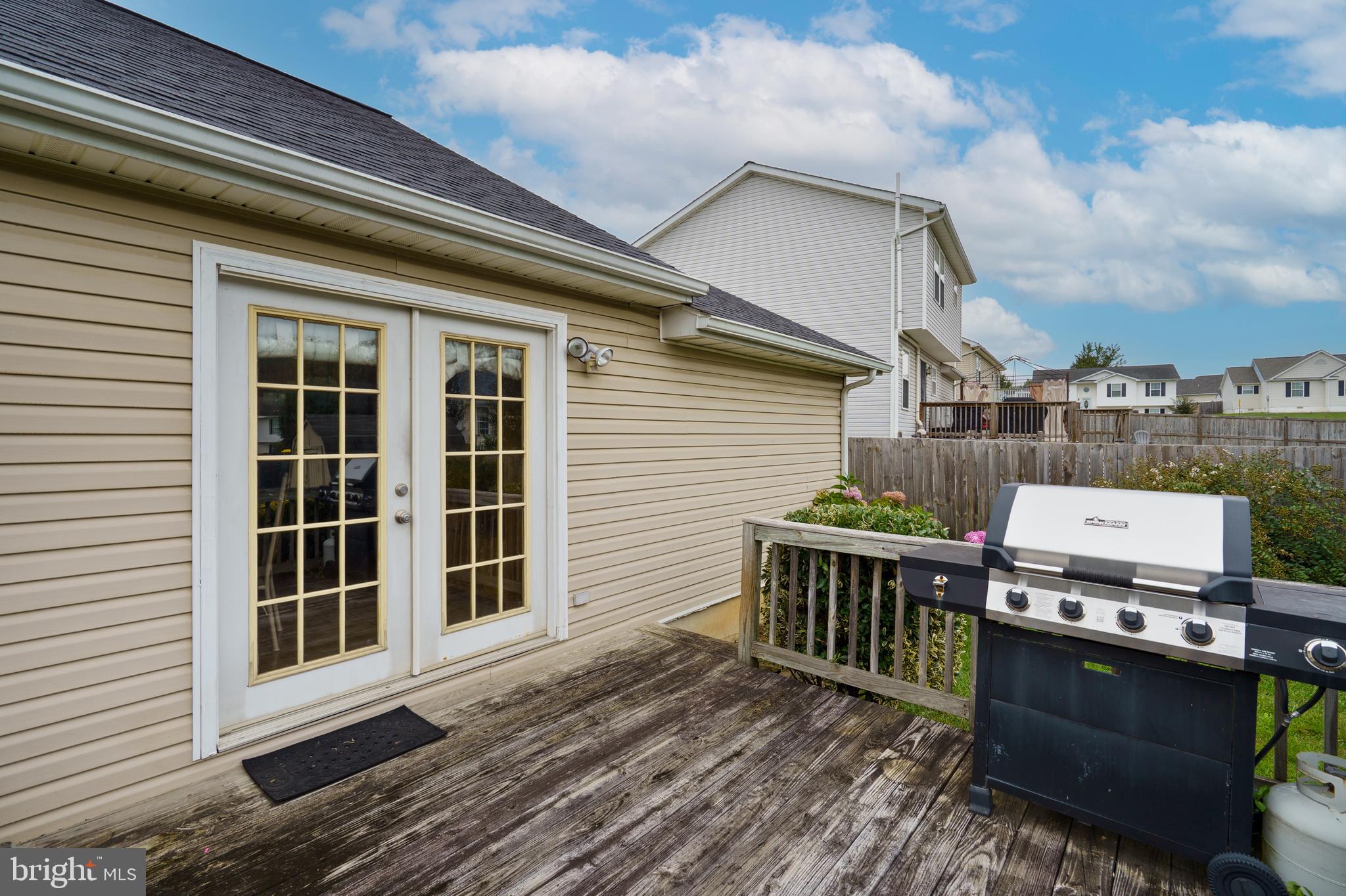 112 Brin Drive Ranson, WV 25438 - Photo 23 of 26 a view of a deck with table and chairs and wooden floor