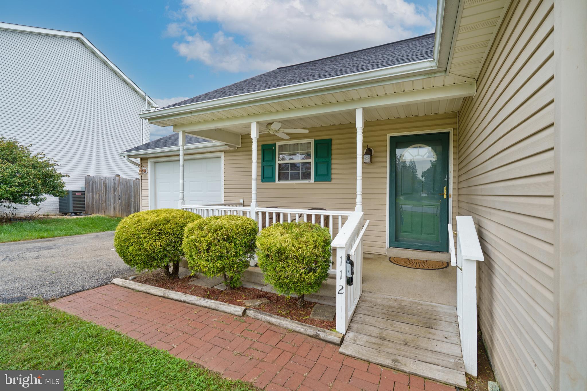112 Brin Drive Ranson, WV 25438 - Photo 3 of 26 a front view of a house with a yard and potted plants