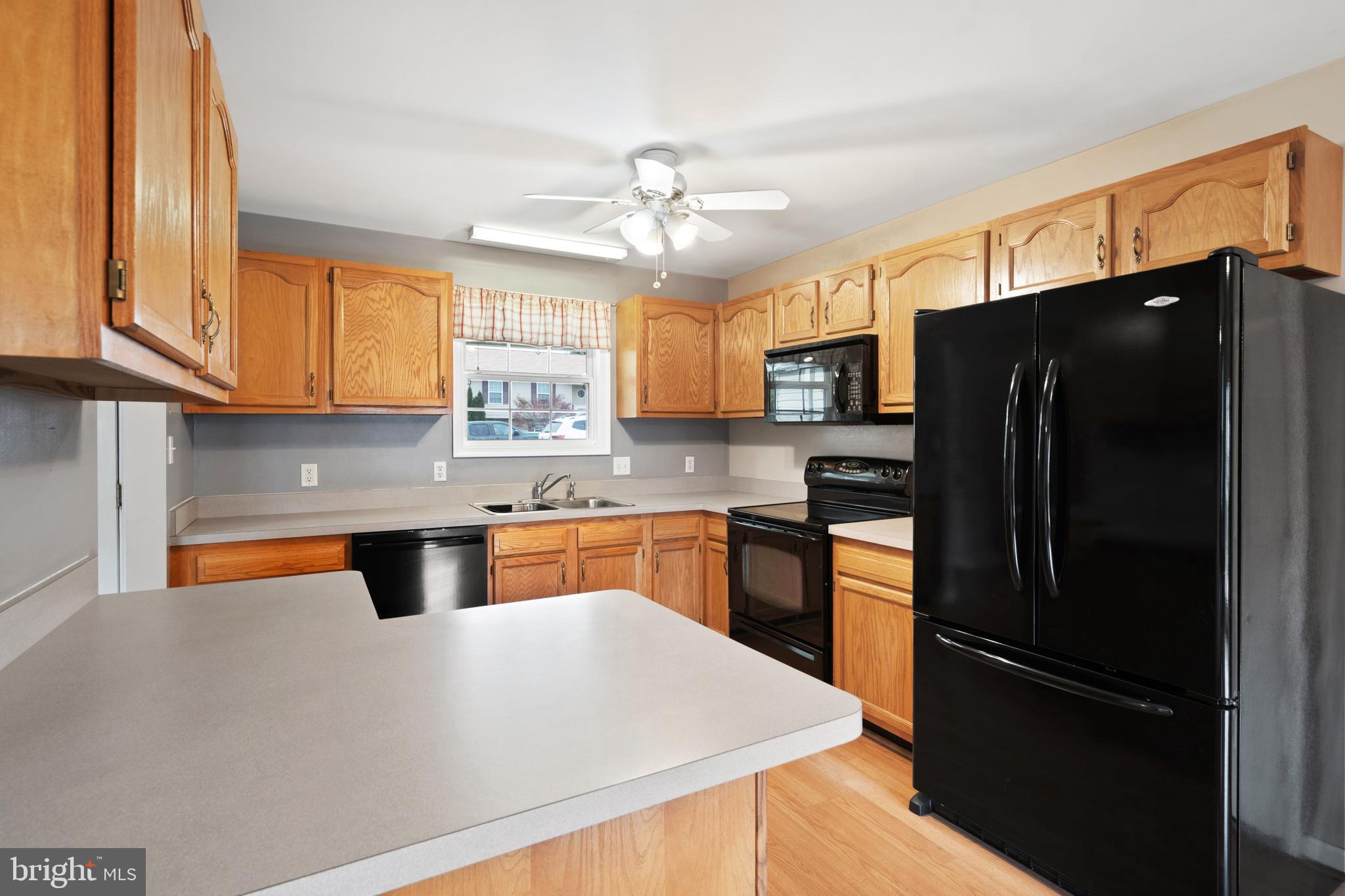 112 Brin Drive Ranson, WV 25438 - Photo 10 of 26 a kitchen with stainless steel appliances granite countertop a refrigerator a sink dishwasher a stove and a refrigerator