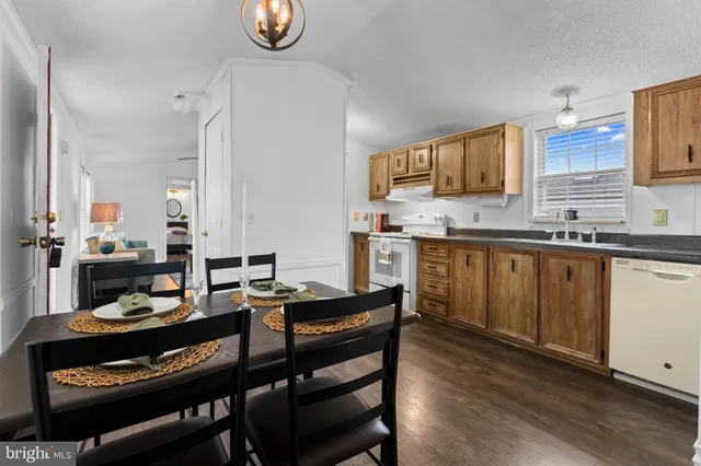 a kitchen with a sink cabinets and wooden floor