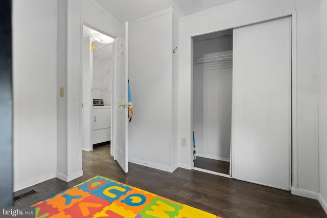 a view of empty room with wooden floor and floor to ceiling window