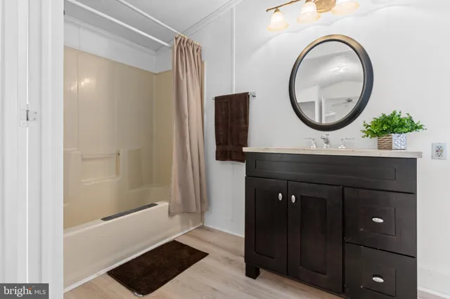 a bathroom with a sink a mirror and a vanity