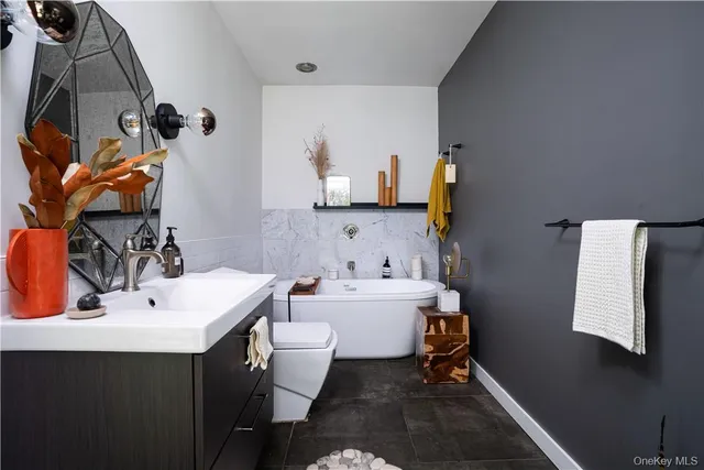 a bedroom with furniture and a flat screen tv