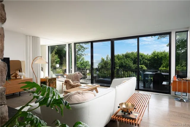 a living room with furniture and a floor to ceiling window